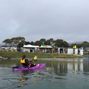 A person kayaking to shore.
